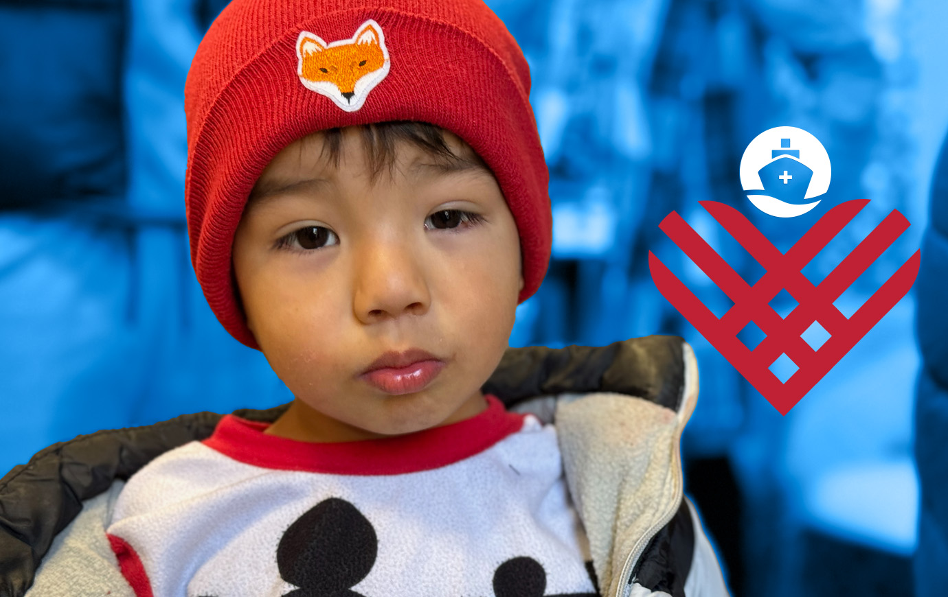 Small boy with a red hat and Giving Tuesday logo